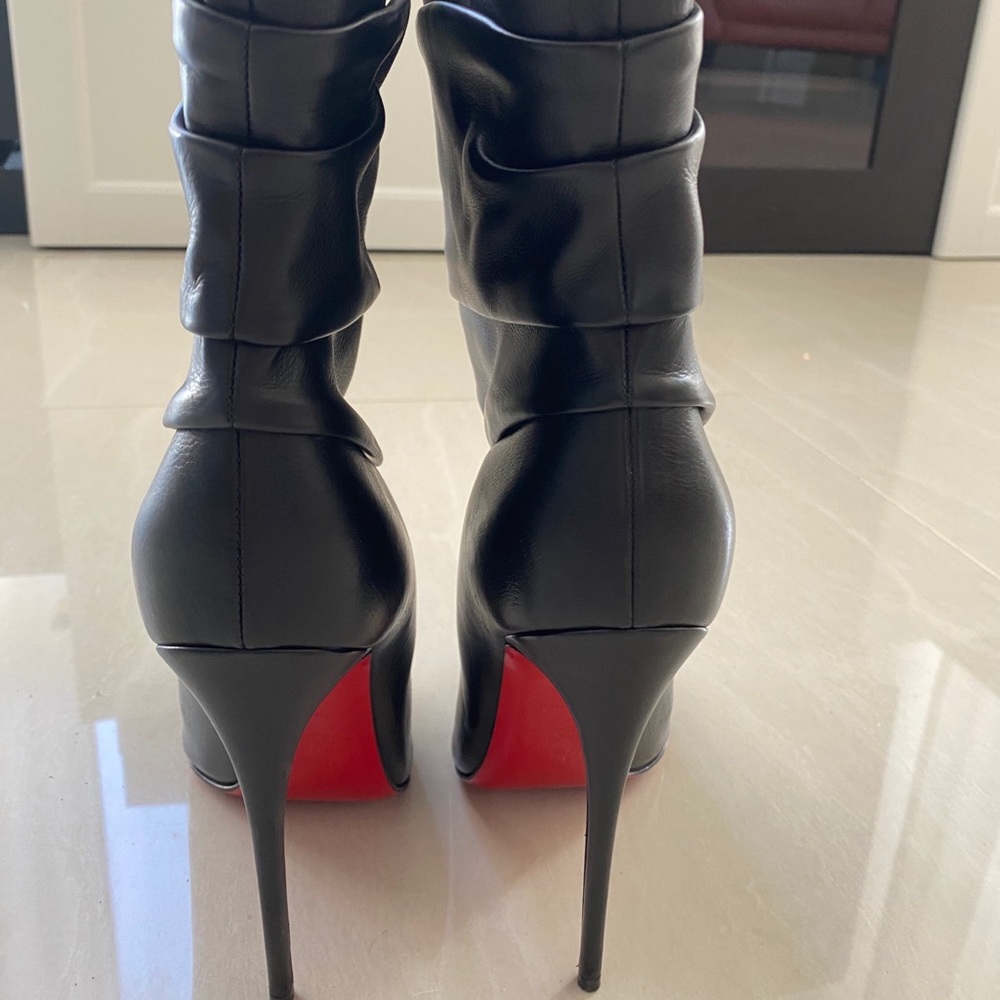 Black Christian Louboutin boots.